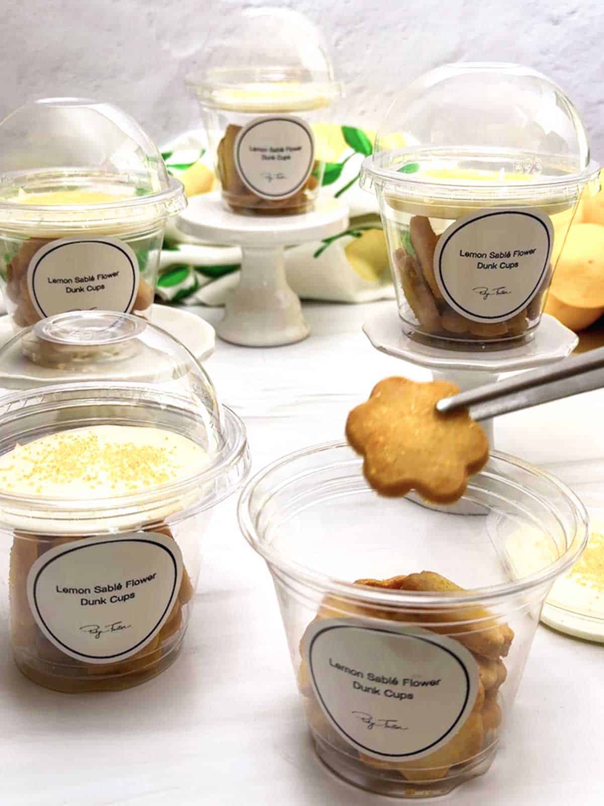 Adding the cookies to the plastic cups.