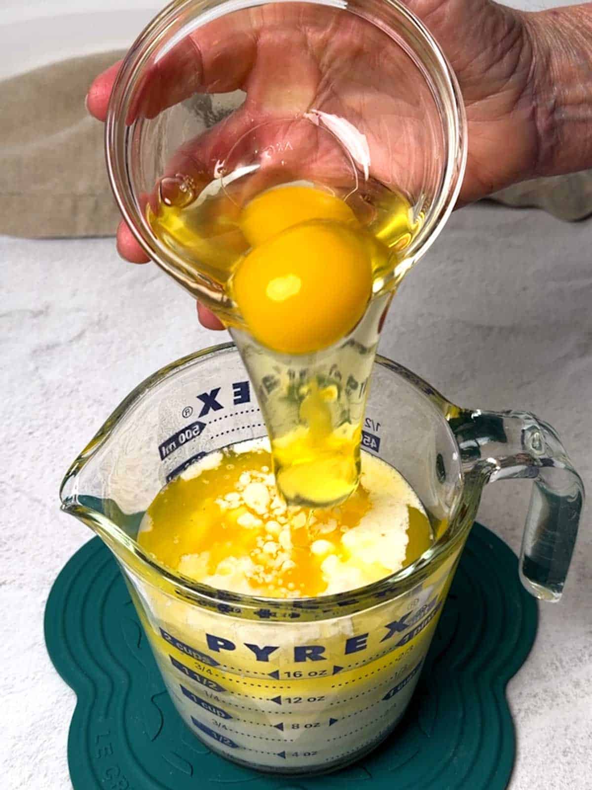 Adding eggs to the wet ingredients.