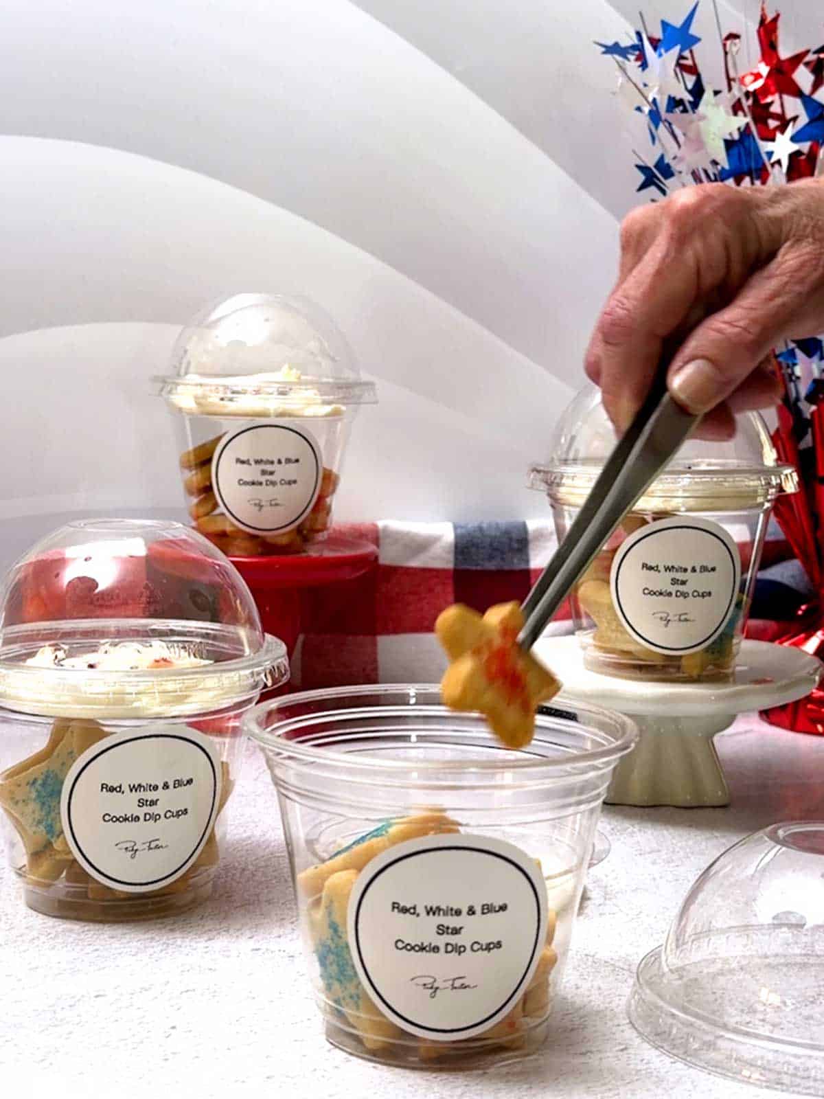 Adding a star cookie to the plastic cup.