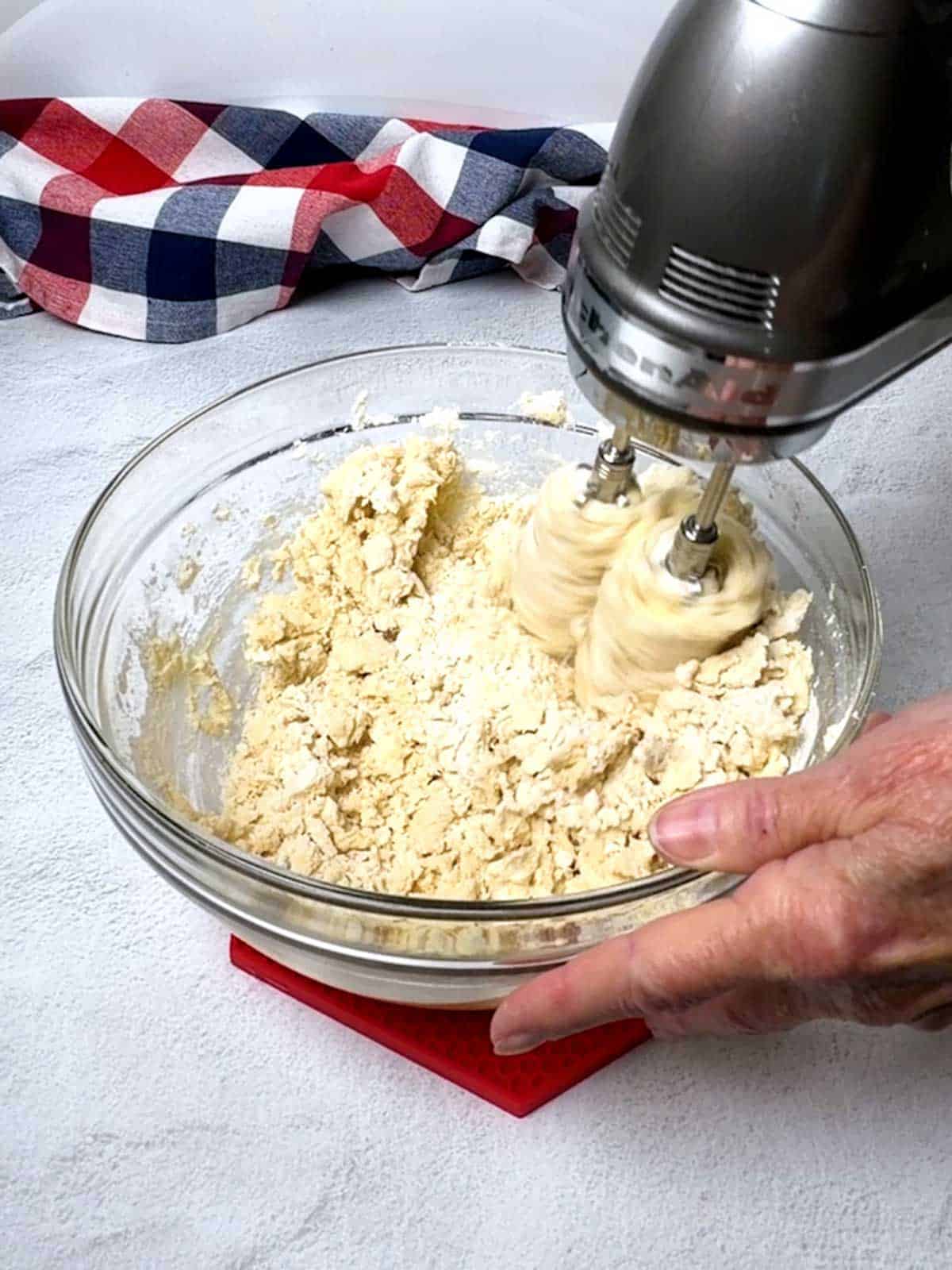 Beating the flour into the dough for the cookies.