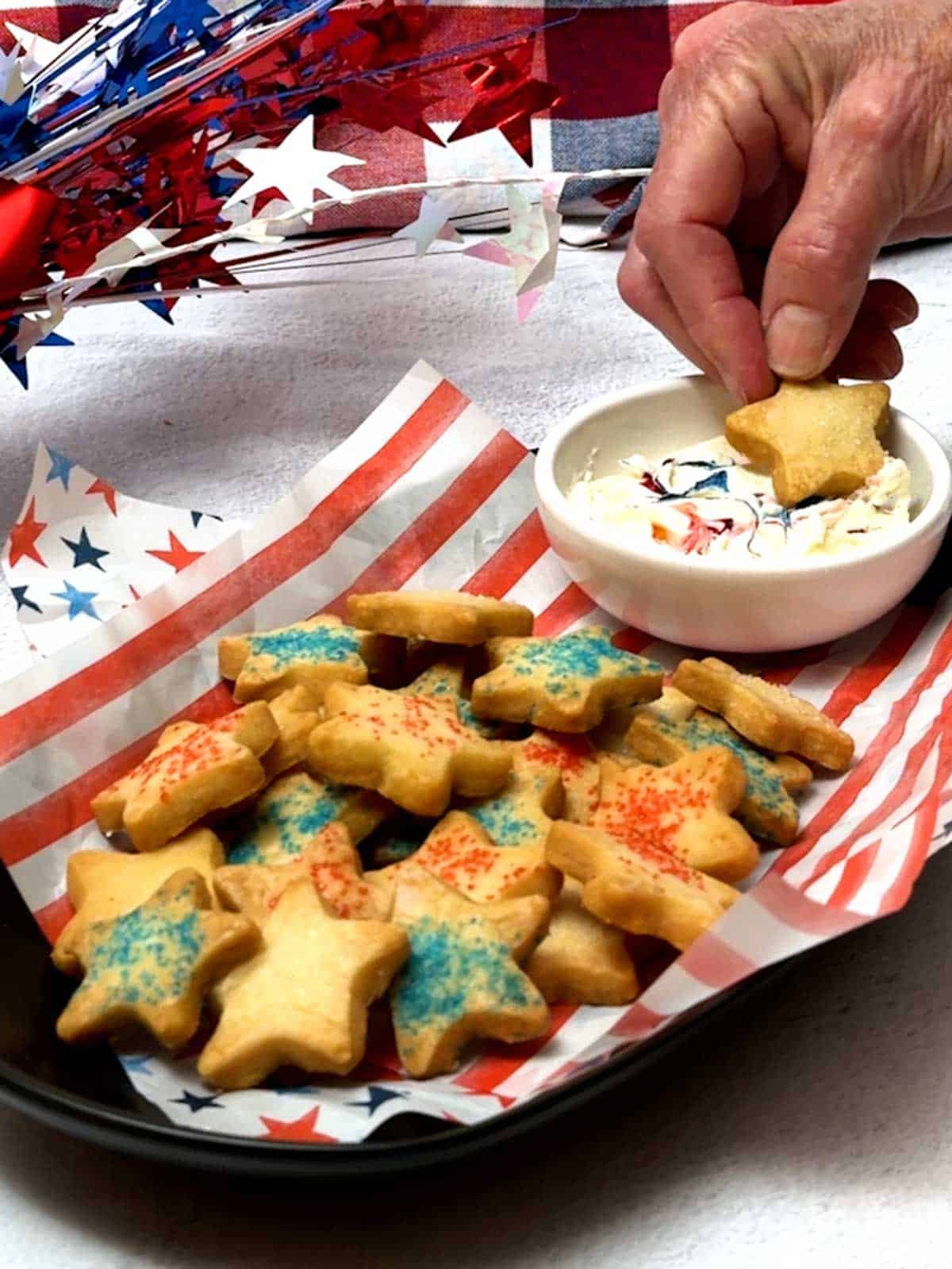Dipping the star cookie in the marshmallow cream dip.