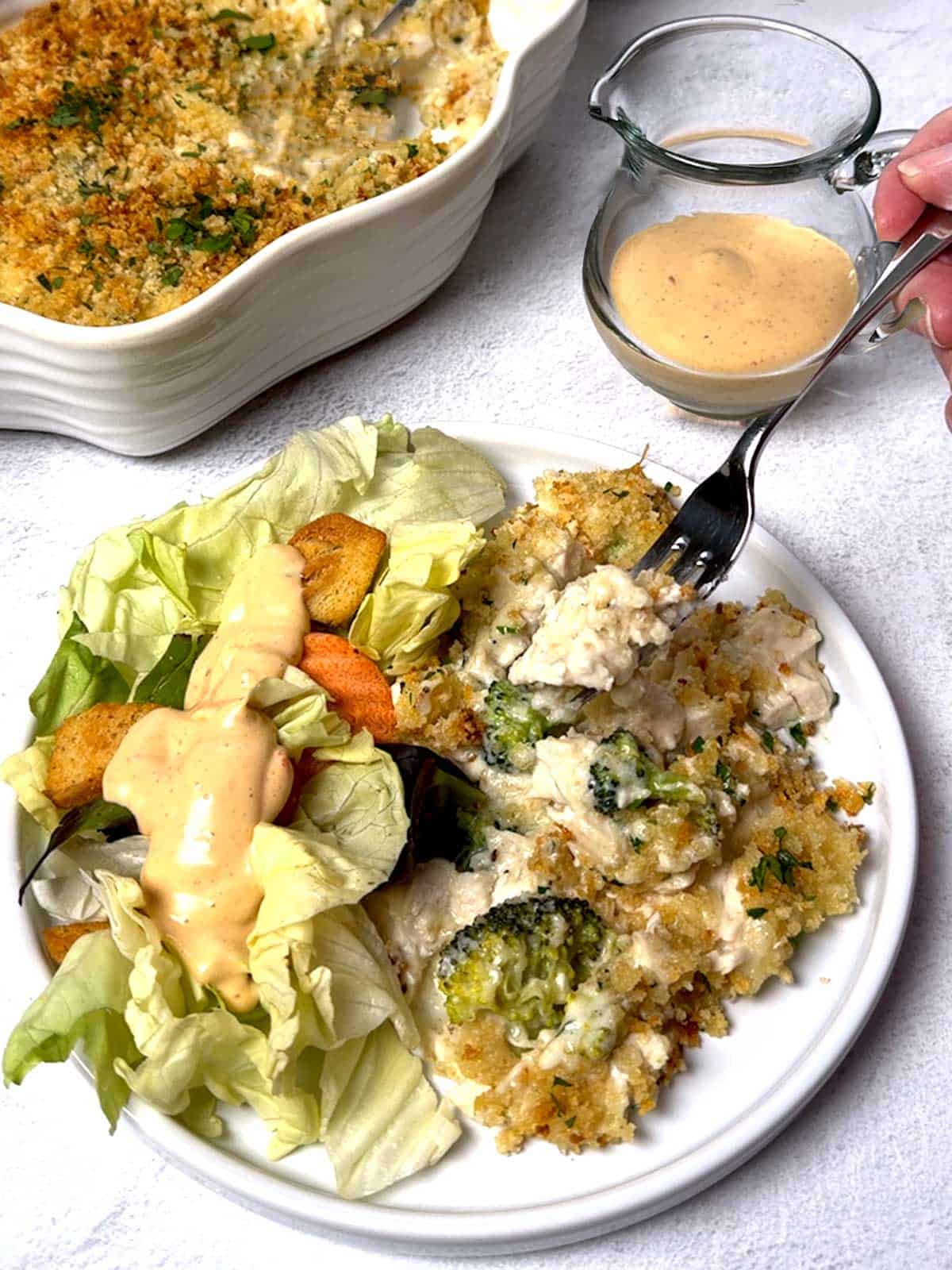 Chicken Divan served with a salad.