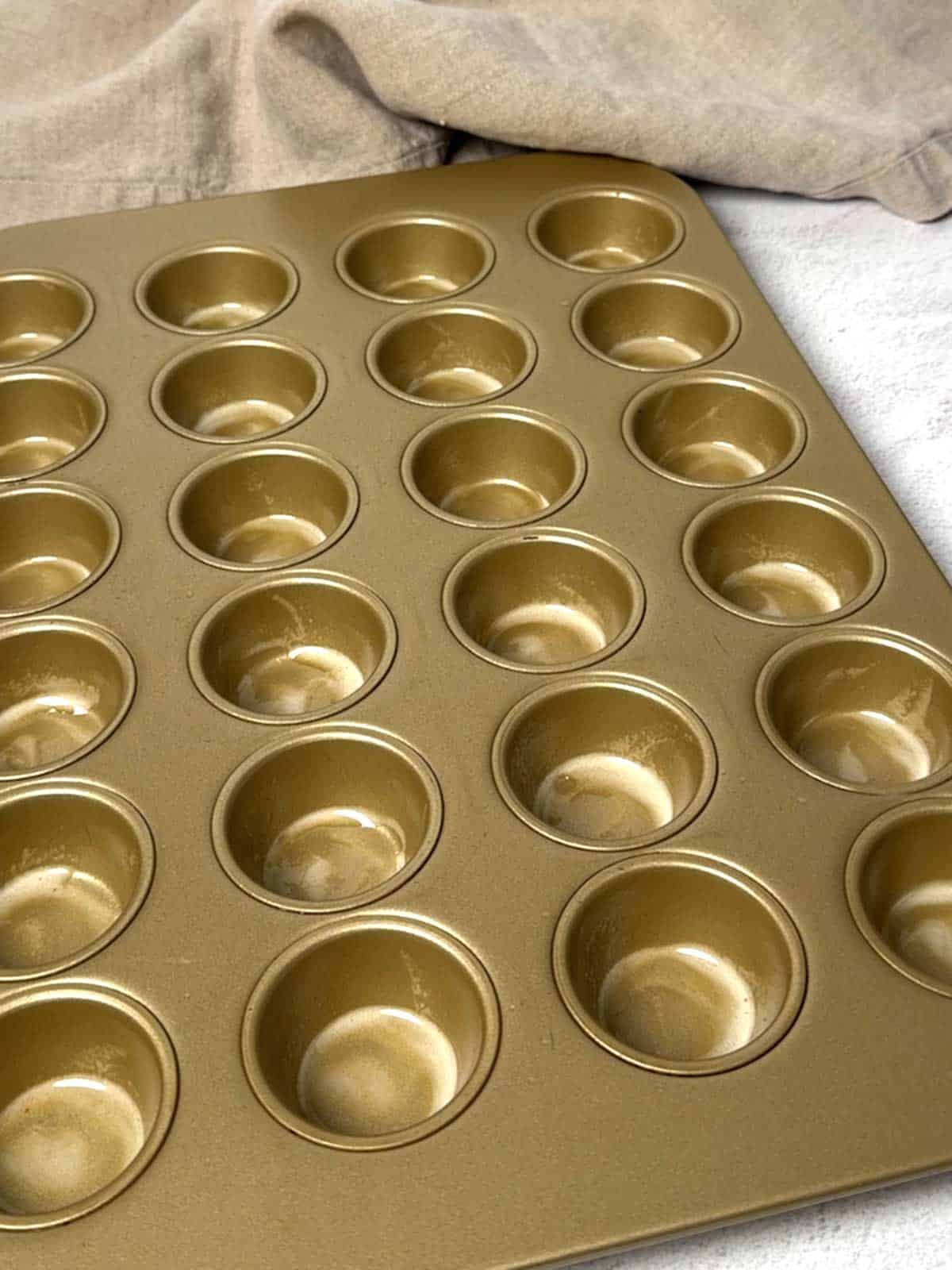 Mini muffin pan sprayed with non-stick spray.