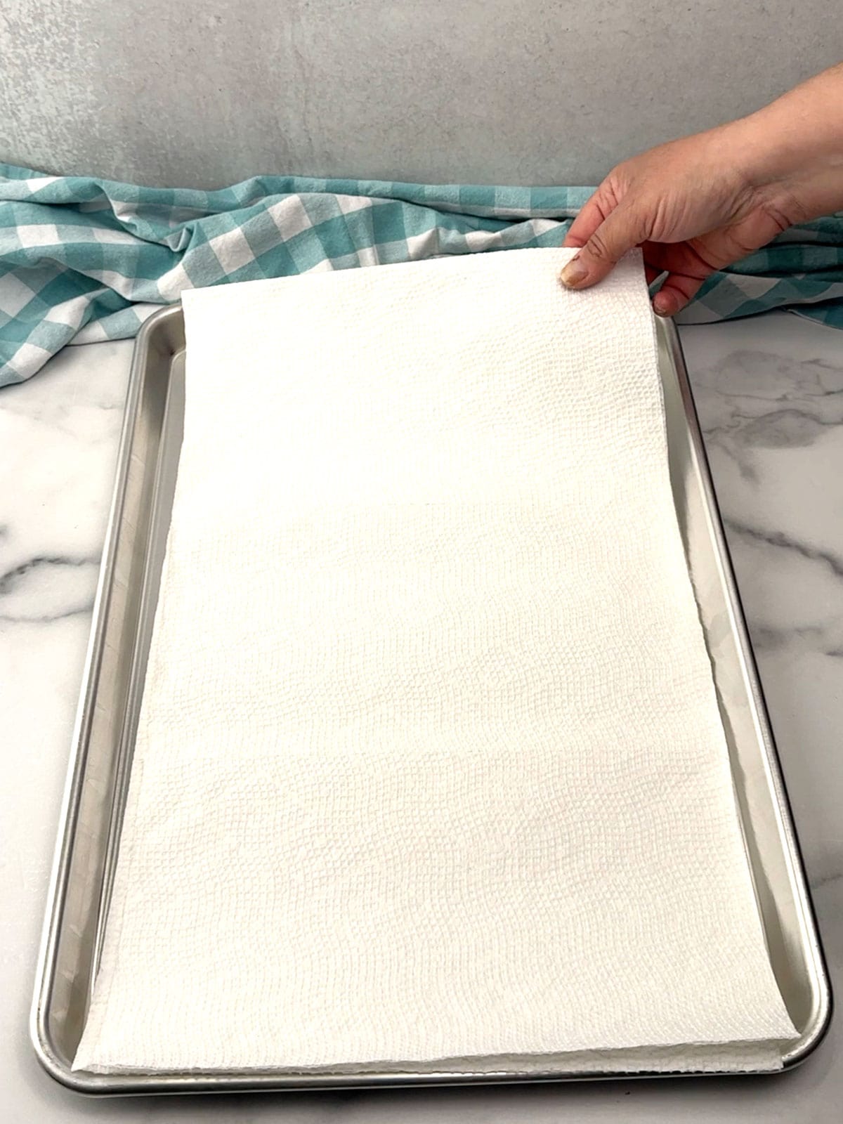 lining a sheet pan with paper towels