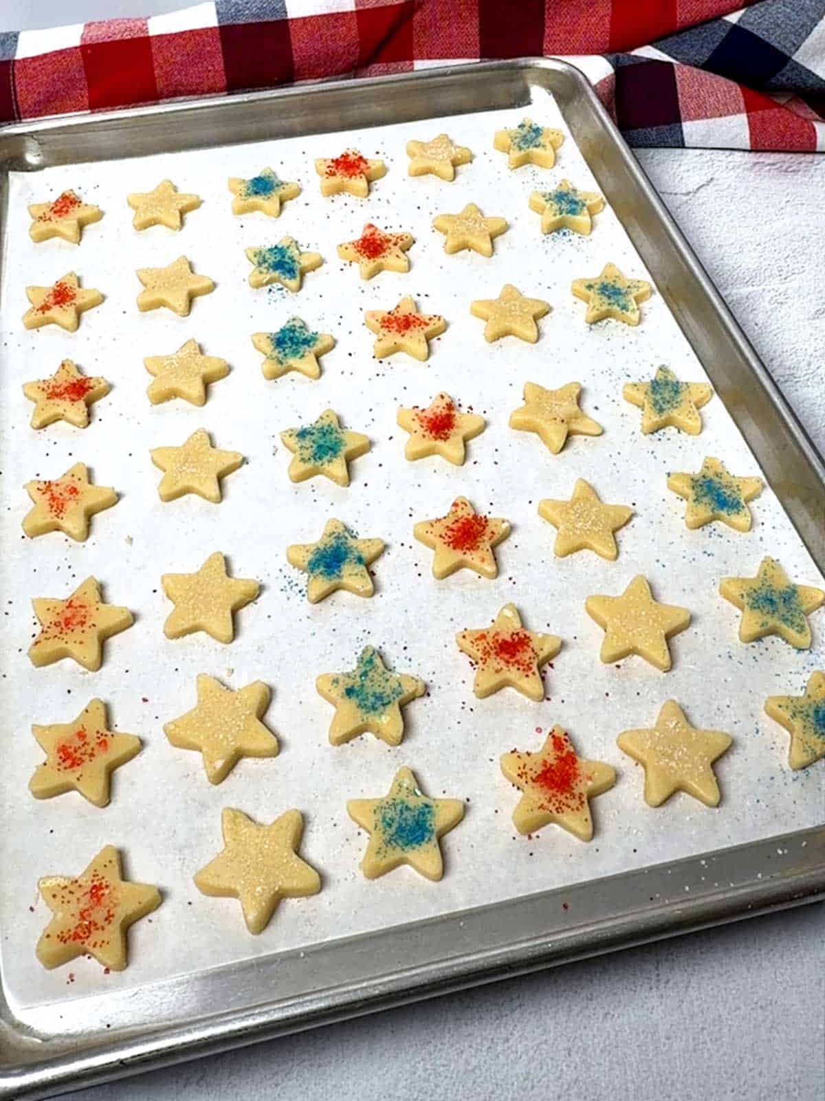 Cookies sprinkled with red, white, and blue sanding sugar, ready for the oven.