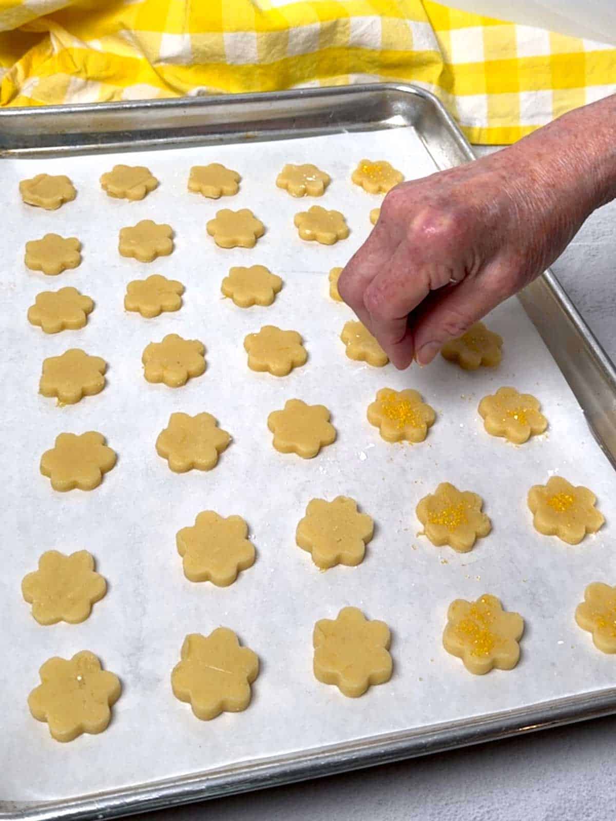 Adding sanding sugar to the cookies.