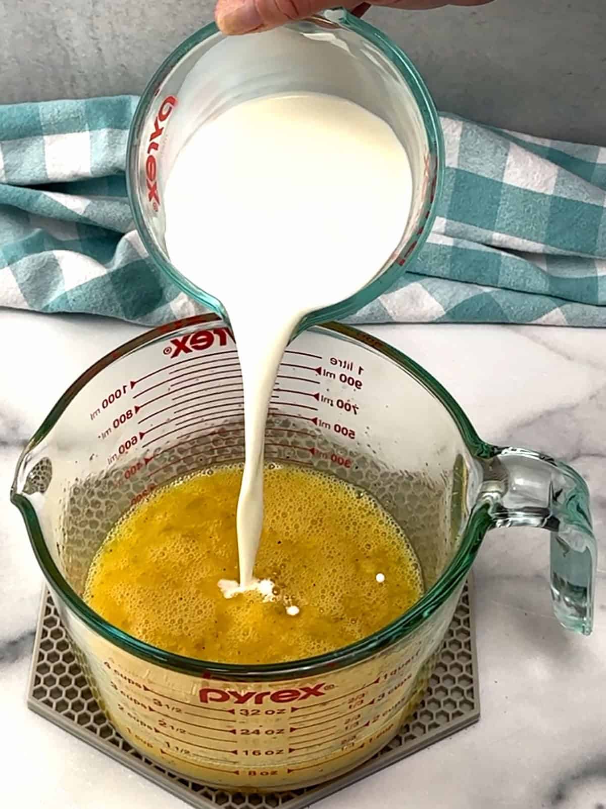 whisking milk into eggs