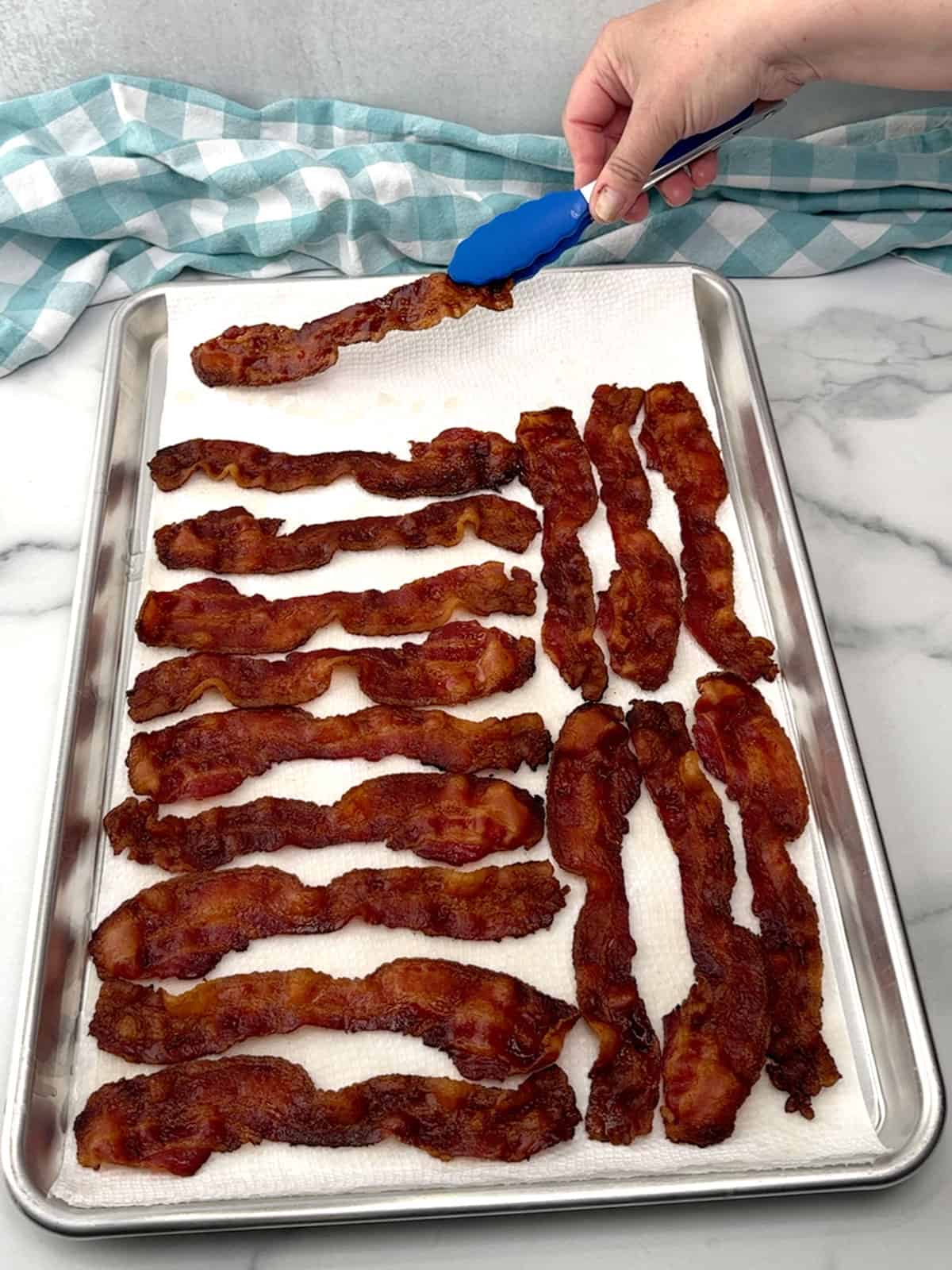 transferring cooked bacon to paper towels