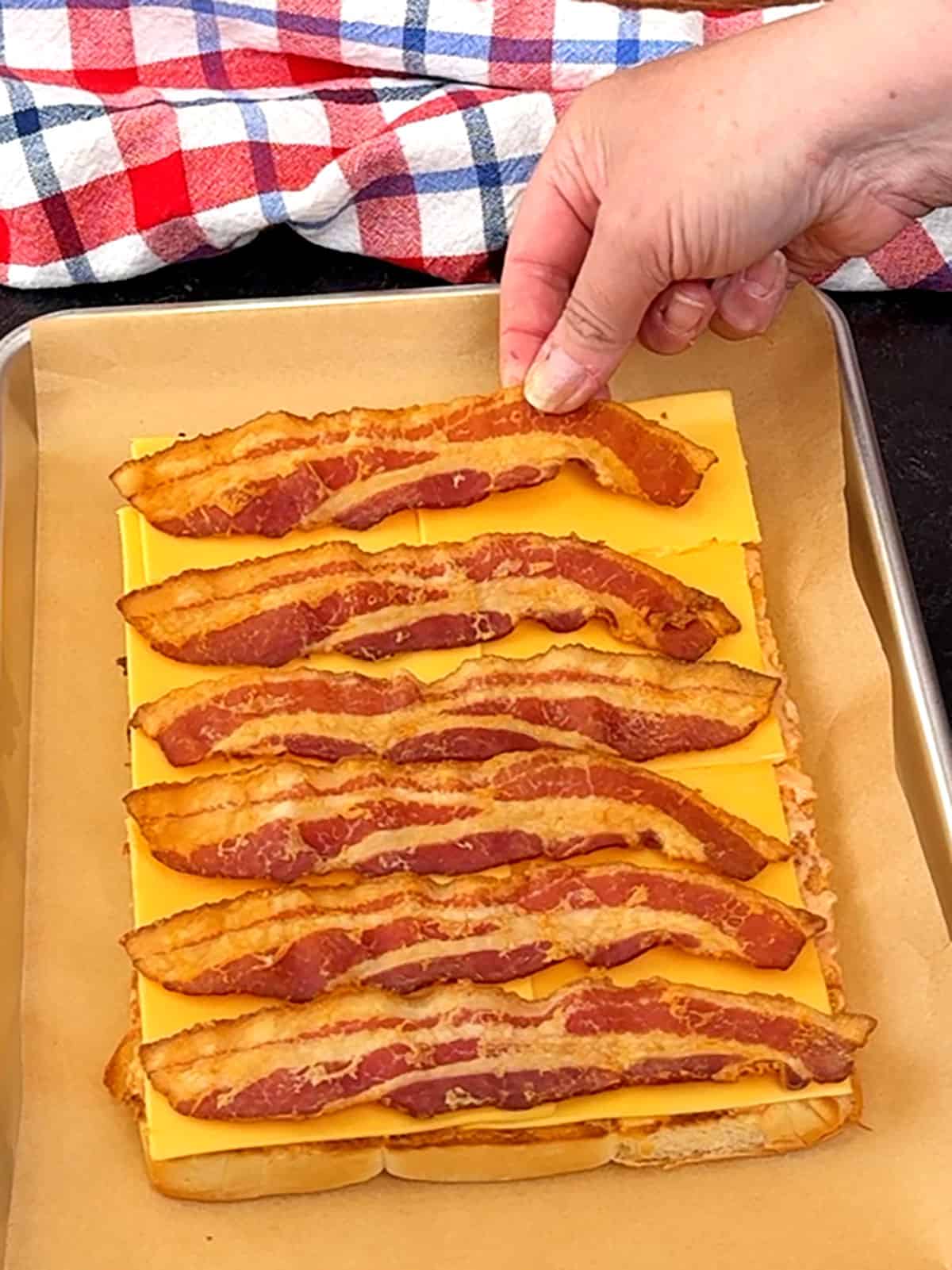 placing bottom layer of bacon