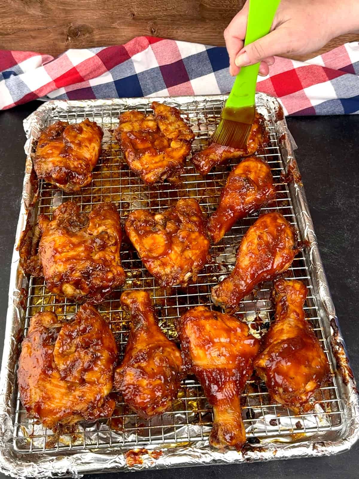 brushing chicken with additional sauce before broiling