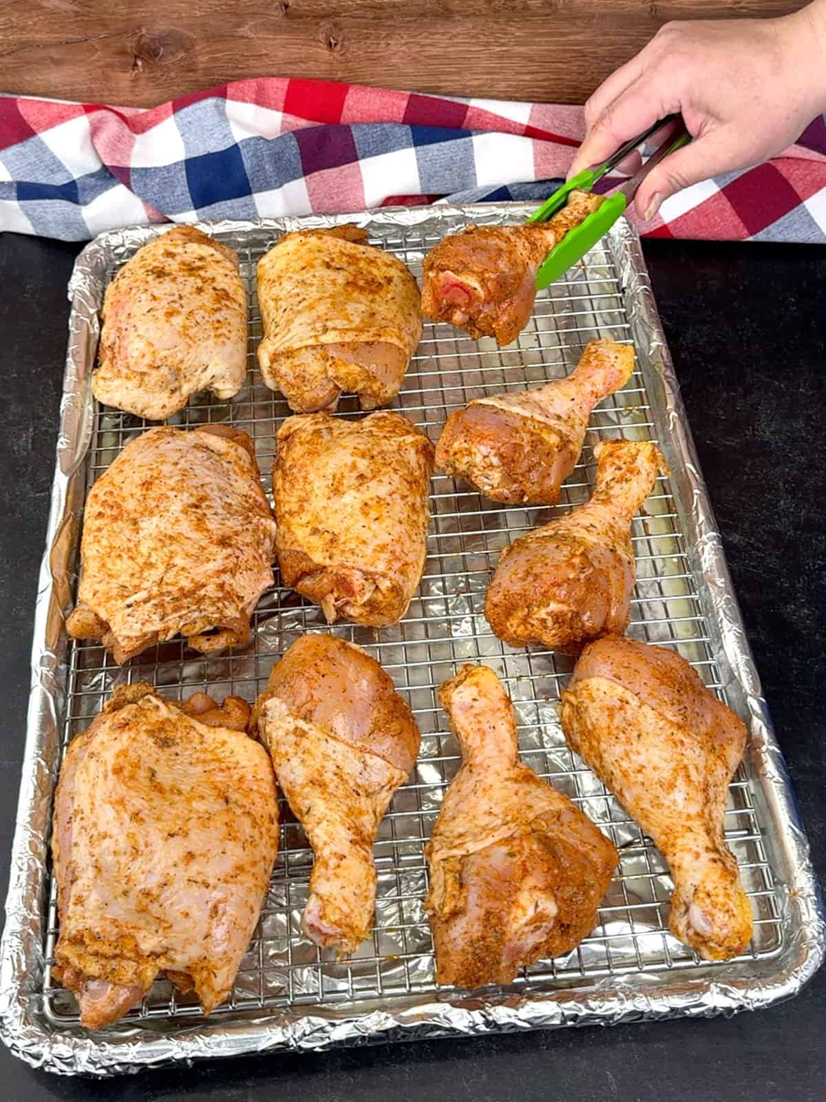 placing prepared chicken pieces on wire rack in prepared pan