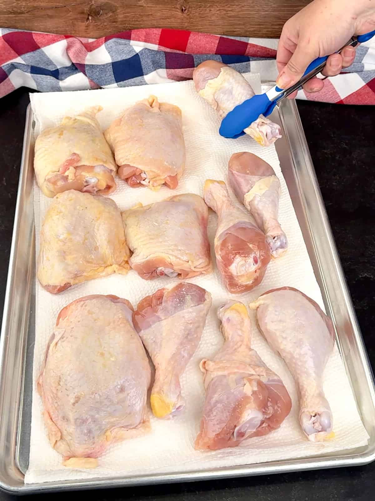 placing chicken pieces on paper towels to dry