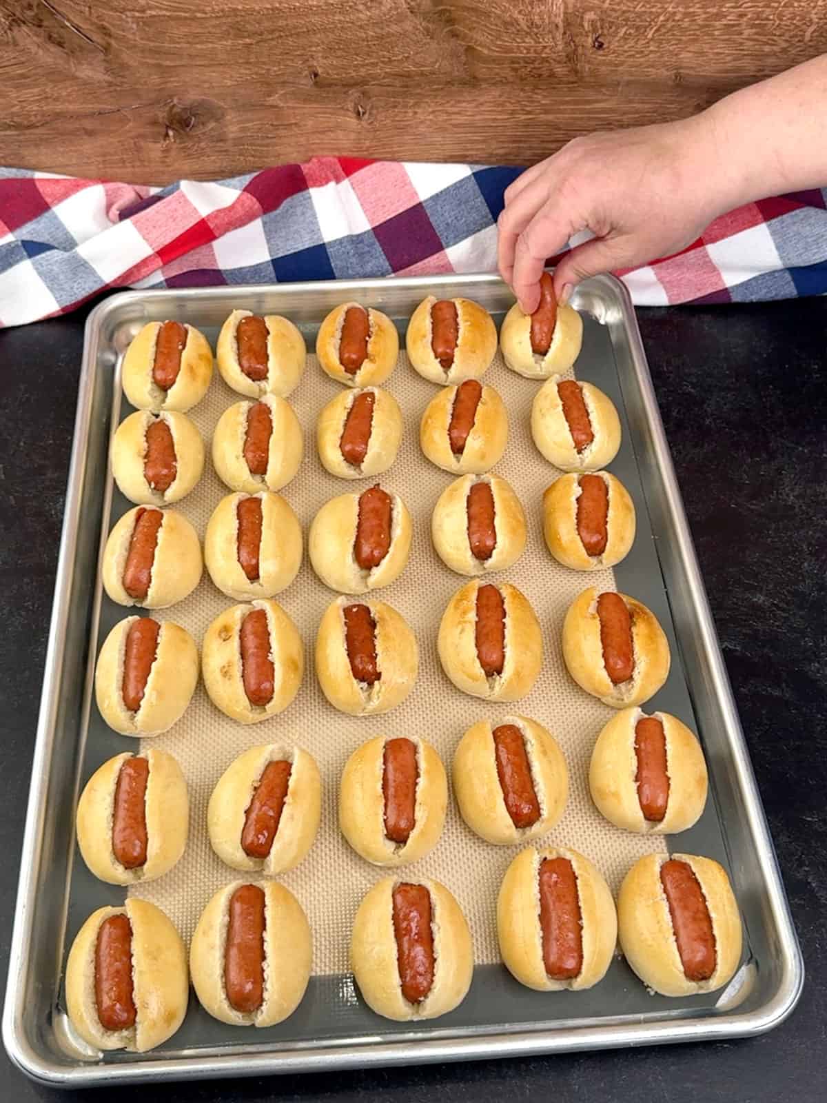 placing Lit'l Smokies into buns