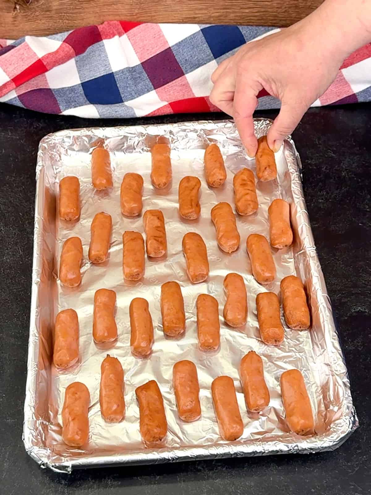 placing Lit'l Smokies on prepared sheet pan