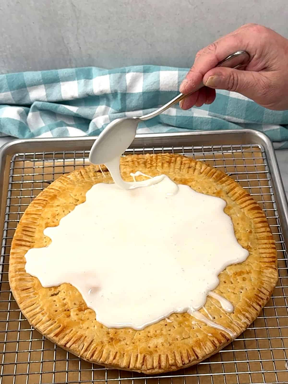 spooning frosting over the top of the pop tart