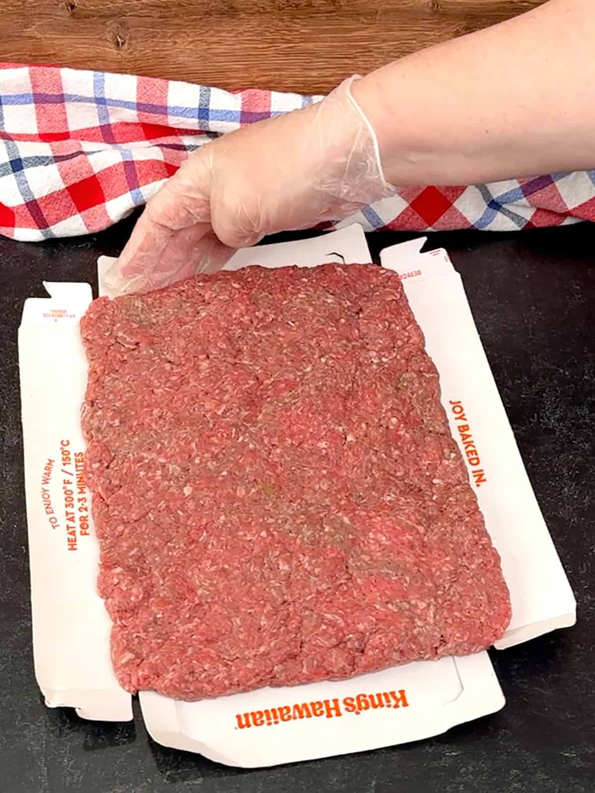 pressing the raw meat larger than the slider bun tray