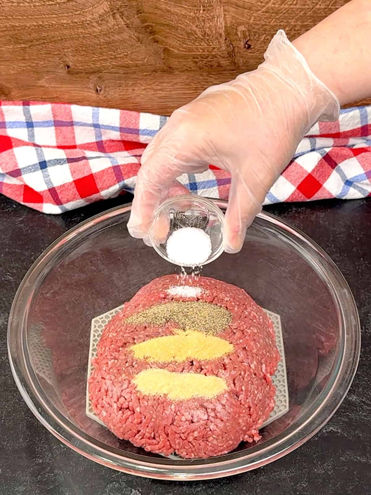 placing meat and spices in bowl