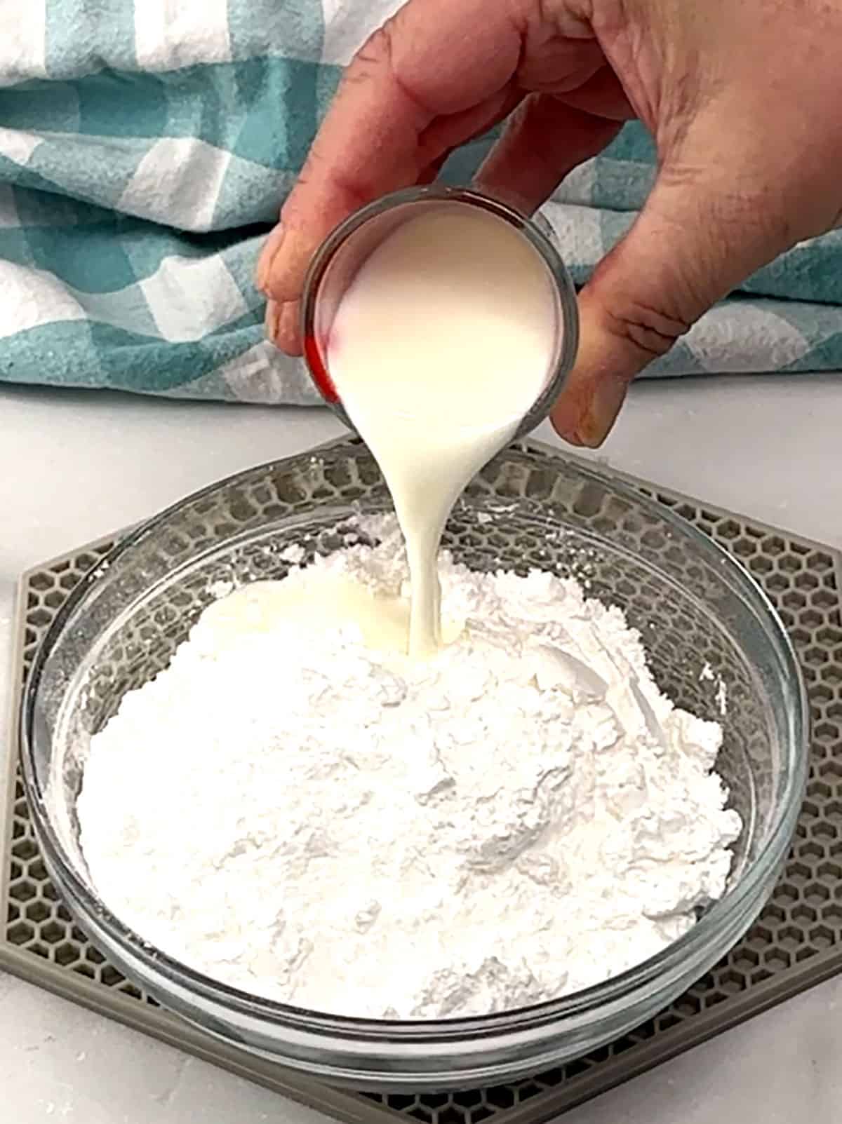 combining milk and powdered sugar for frosting