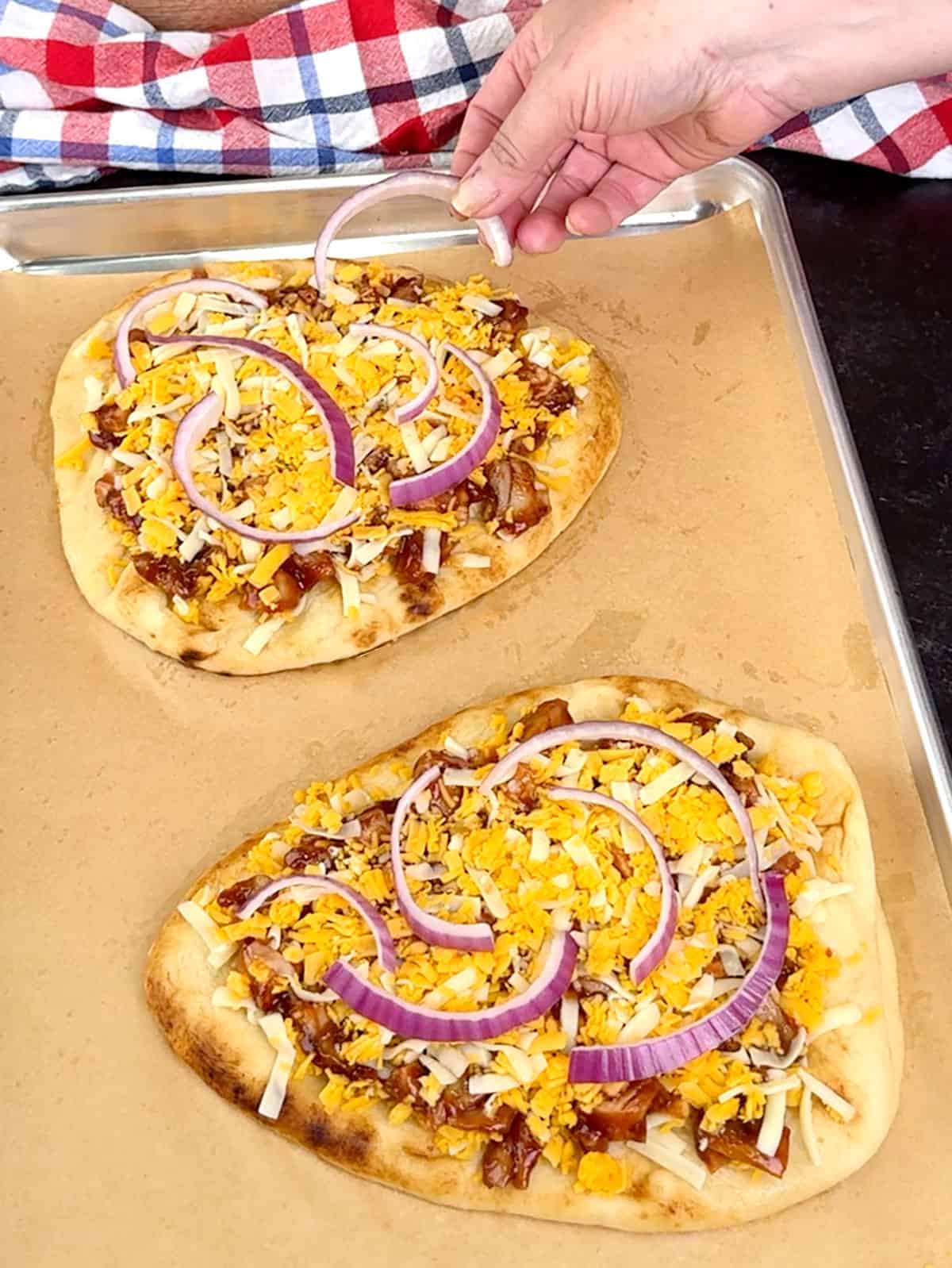 topping pizzas with red onion