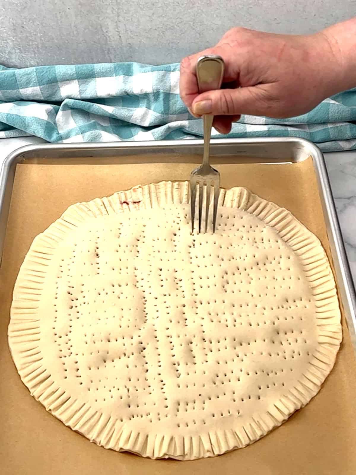 pricking top with a fork