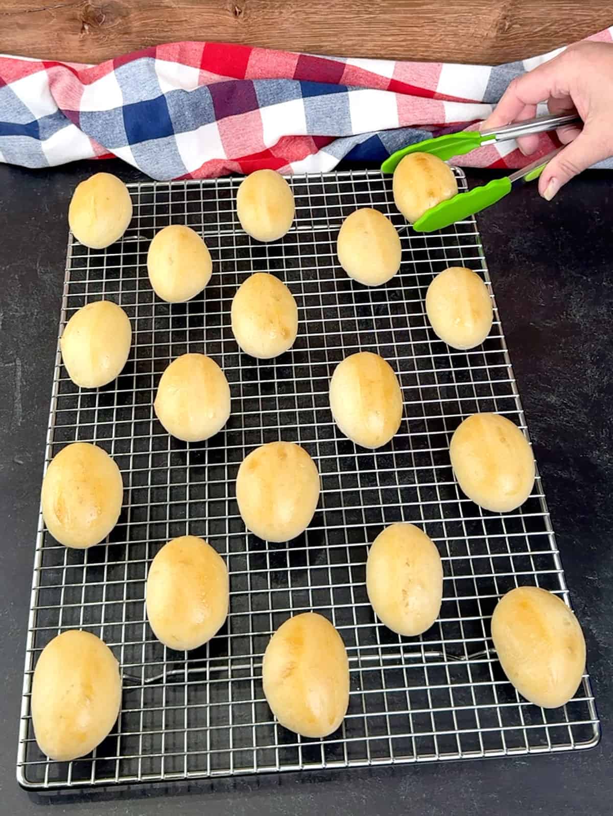 placing baked buns on a wire rack