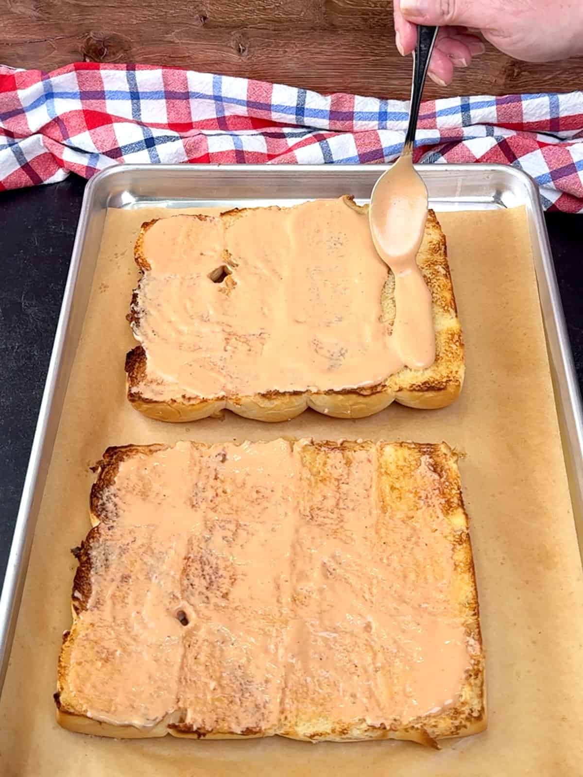 spreading burger sauce on slider buns