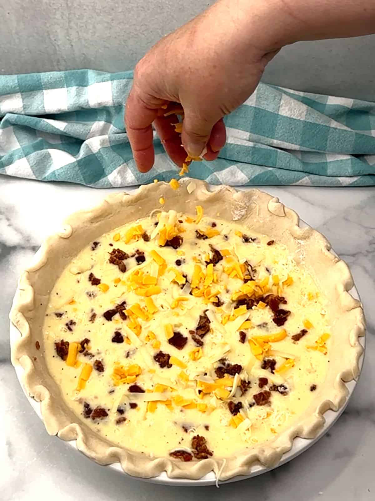 sprinkling reserved bacon and cheese over the top