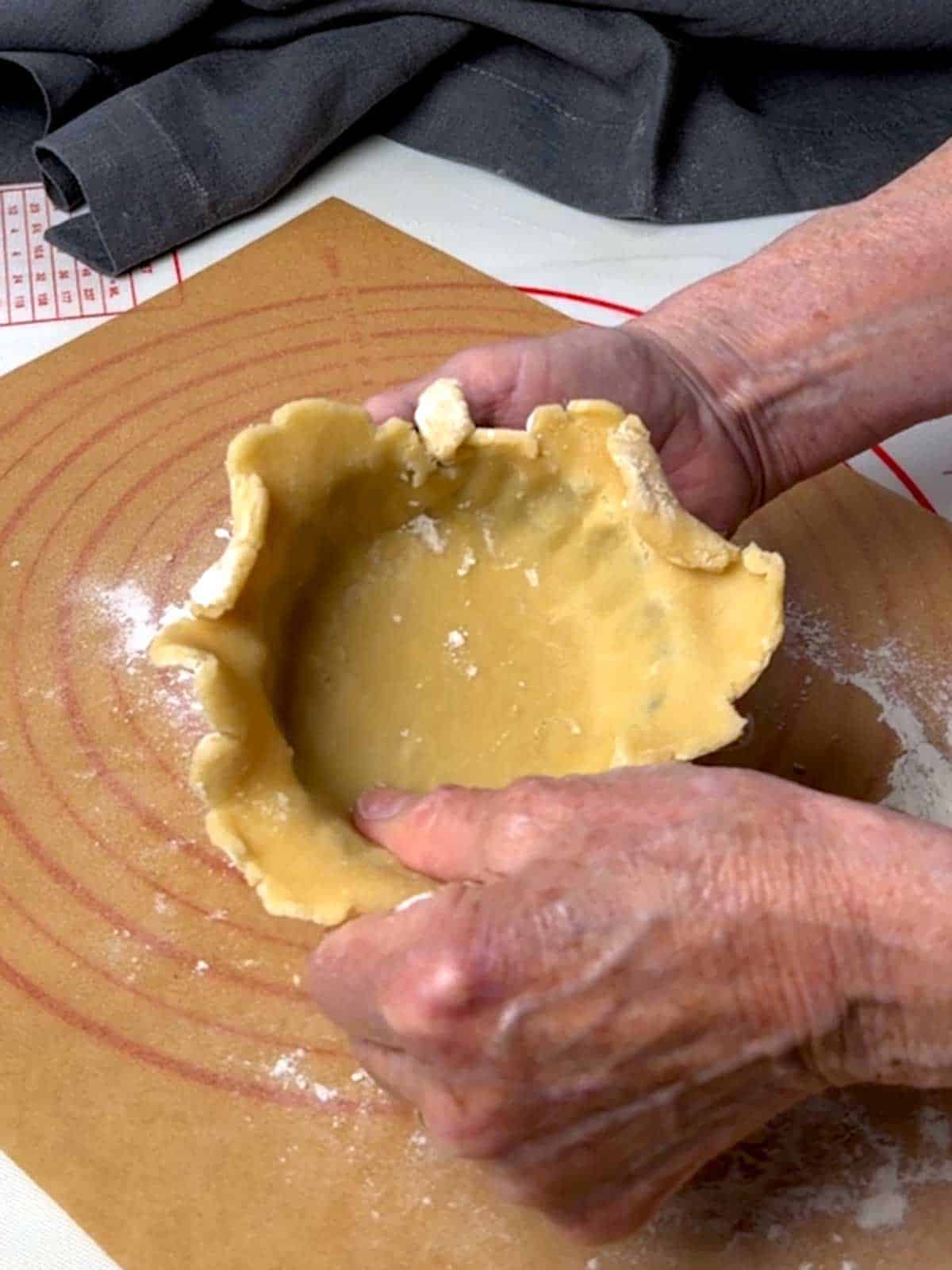 Forming the tart shell in the mini tart pan.