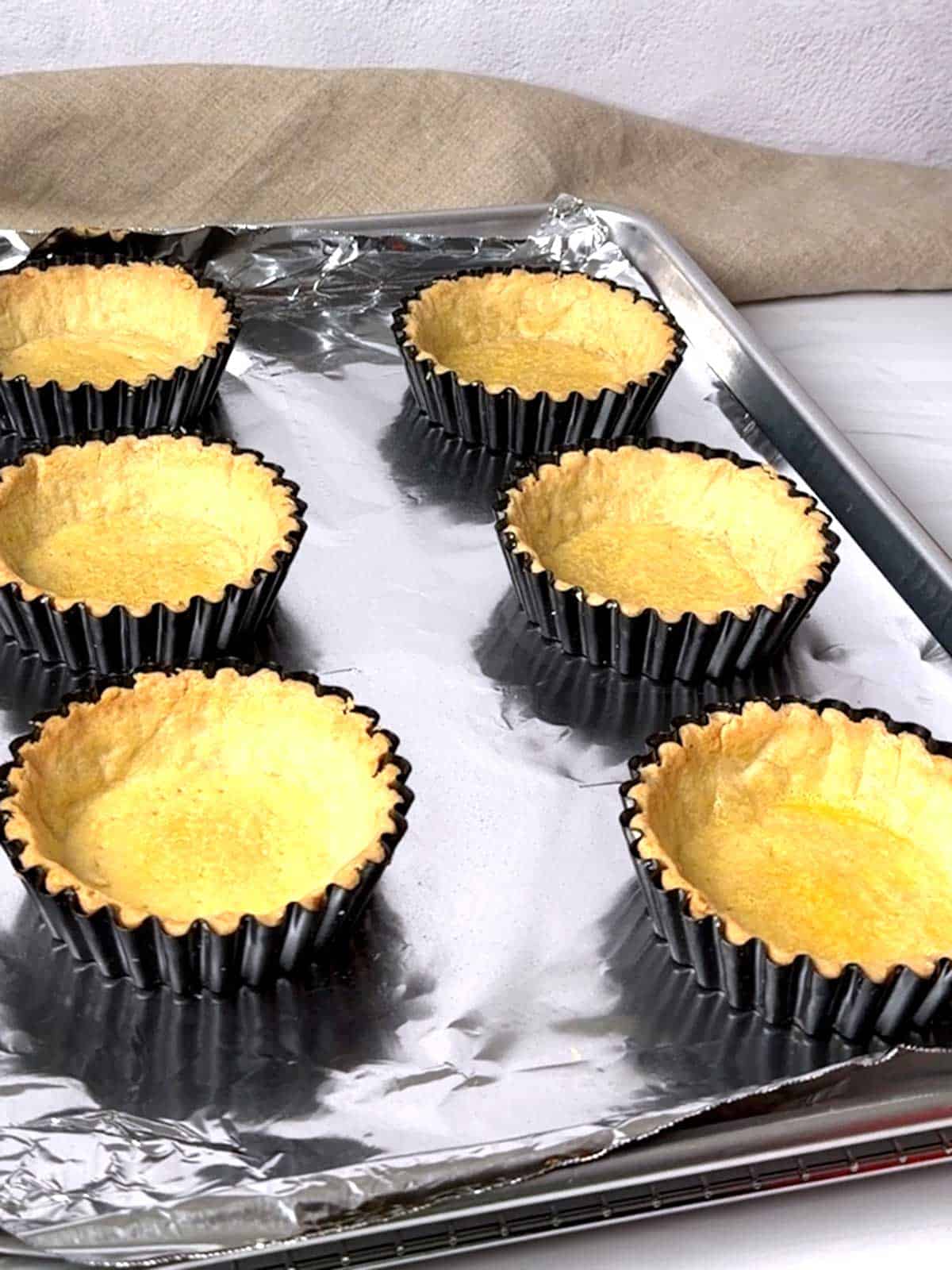 Mini tart shells out of the oven.