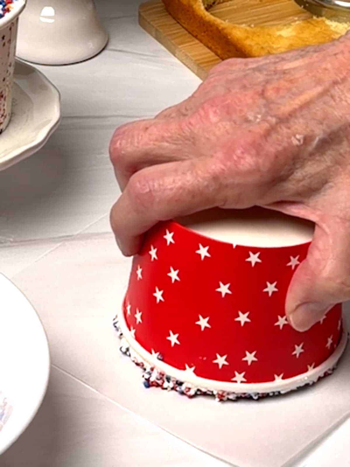 Pressing cup into parchment paper.