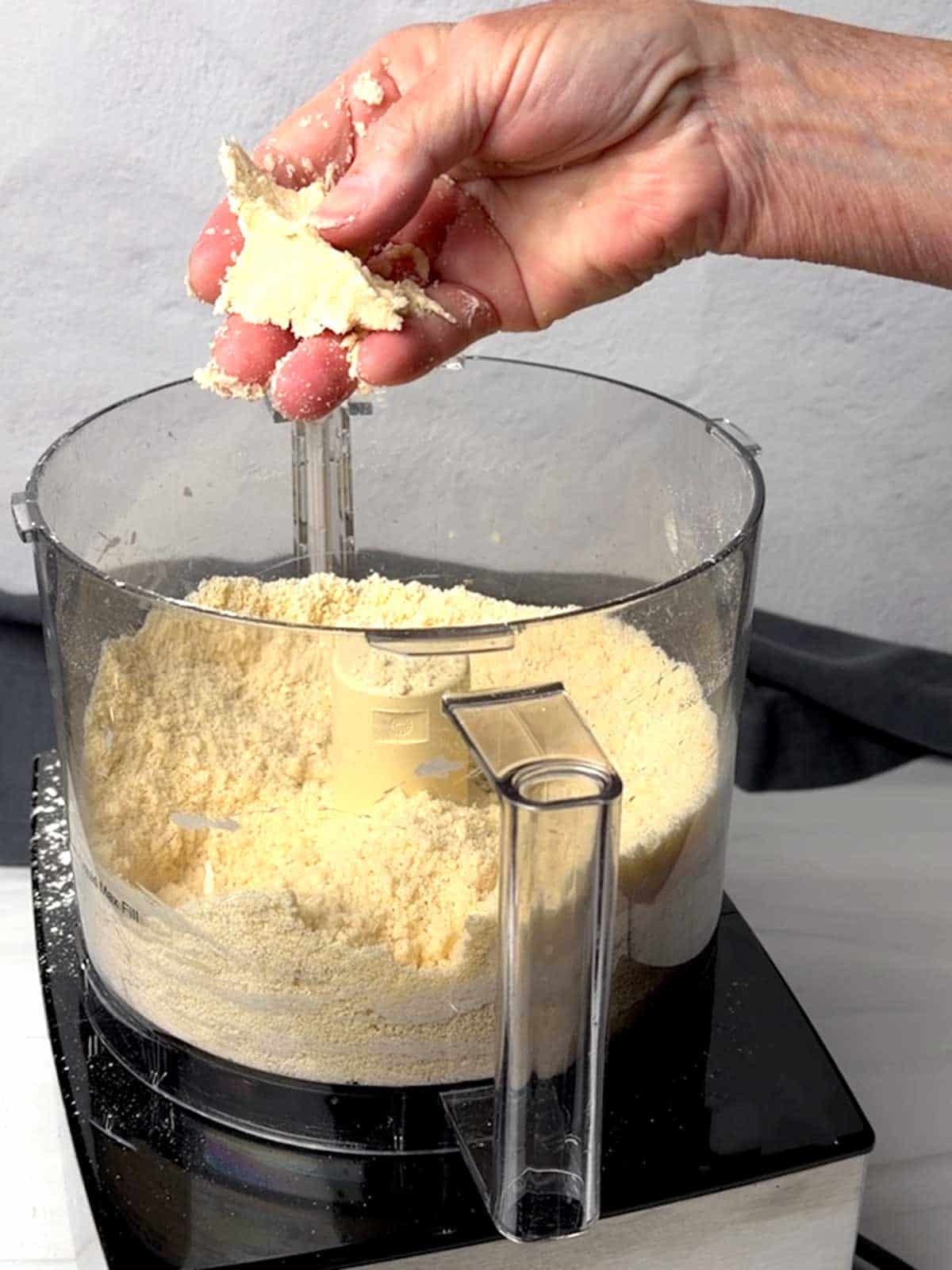 Testing the dough to see if it needs water.