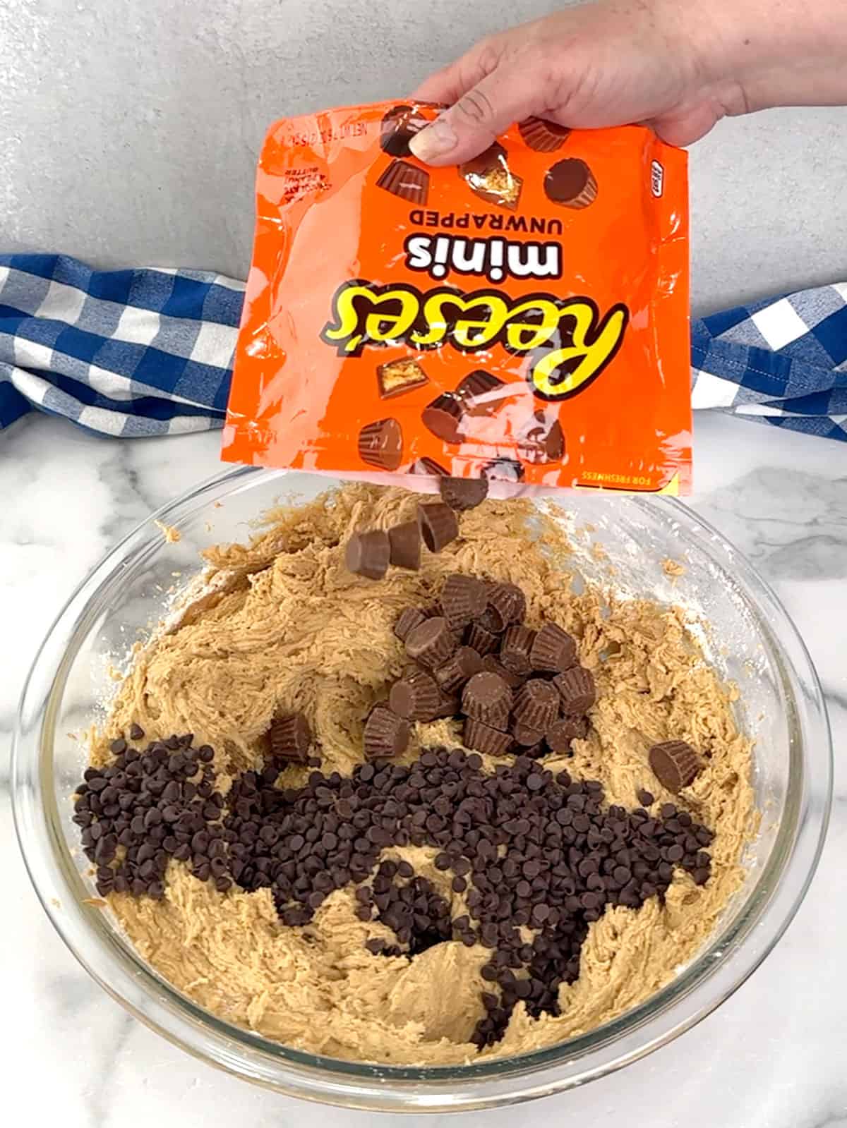 adding chocolate chips and mini Reese's peanut butter cups