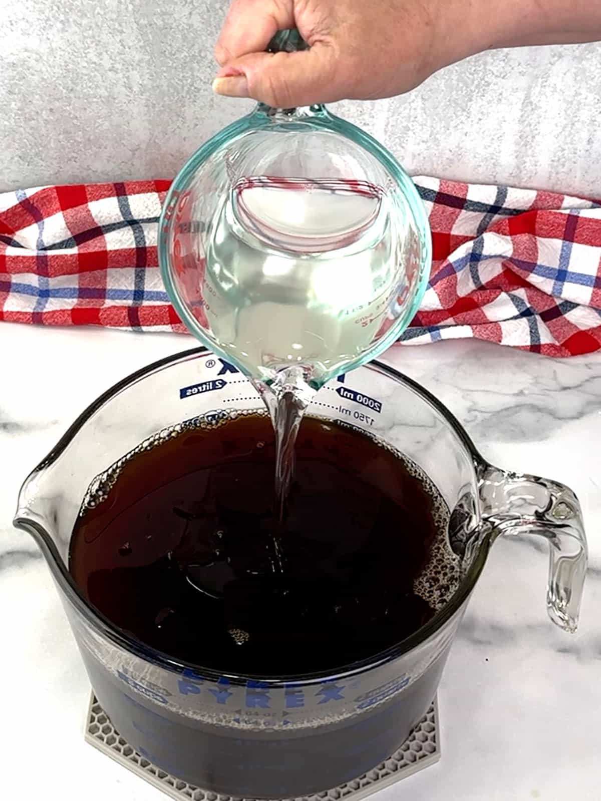 adding simple syrup to tea mixture