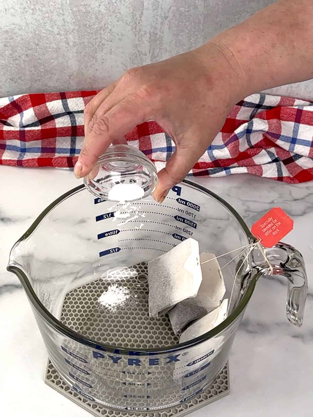tea bags and baking soda in measuring cup