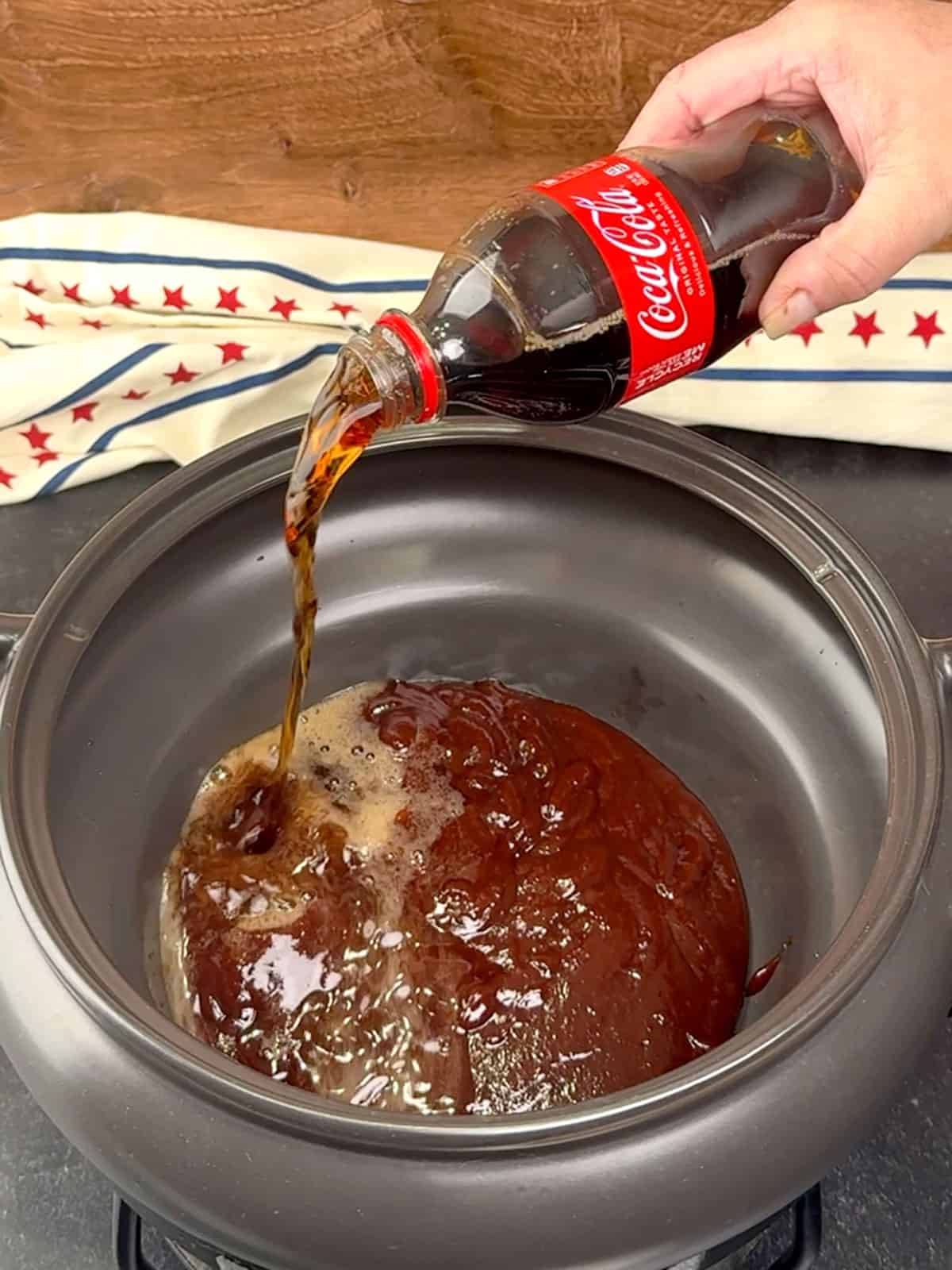 combining cake and barbecue sauce in slow cooker