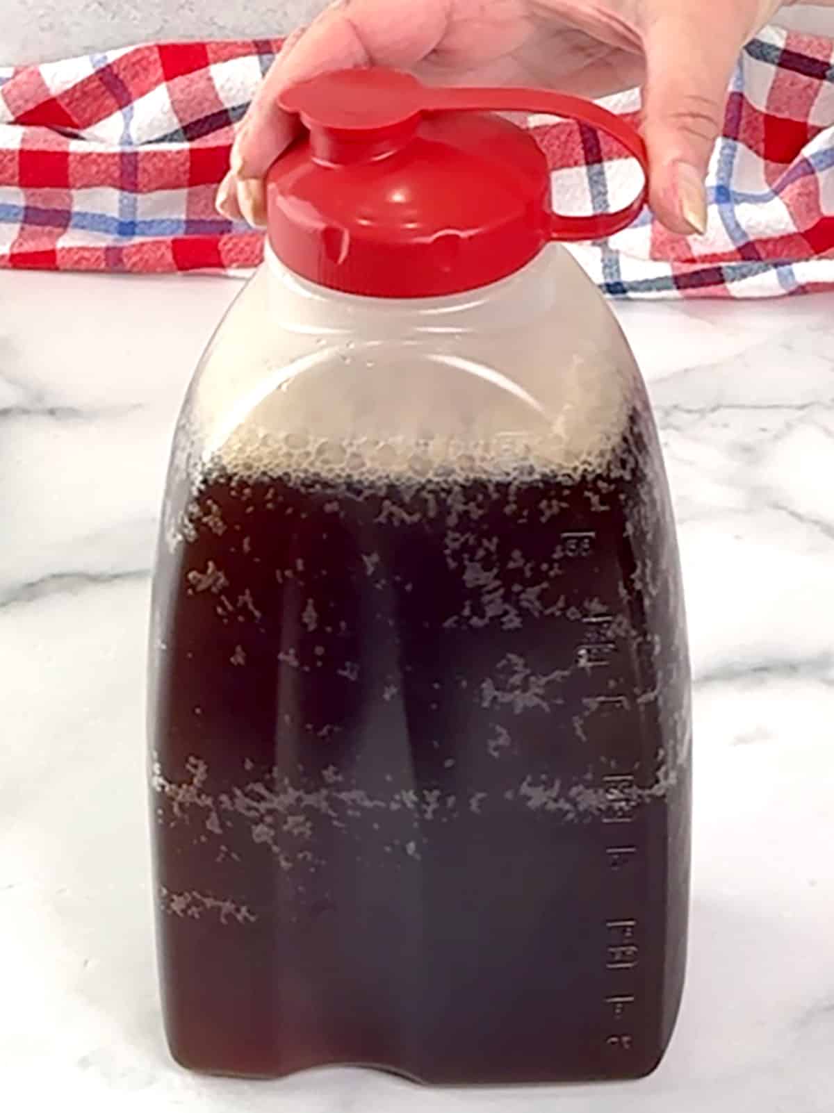 transferring Classic Southern Sweet Tea to container to refrigerate