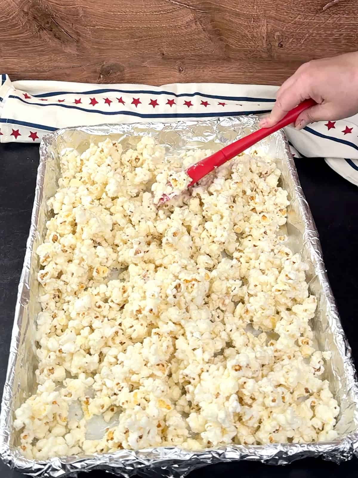 stirring white chocolate with popcorn