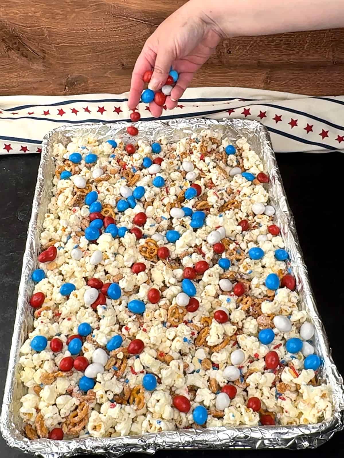 topping popcorn with with holiday m&m's