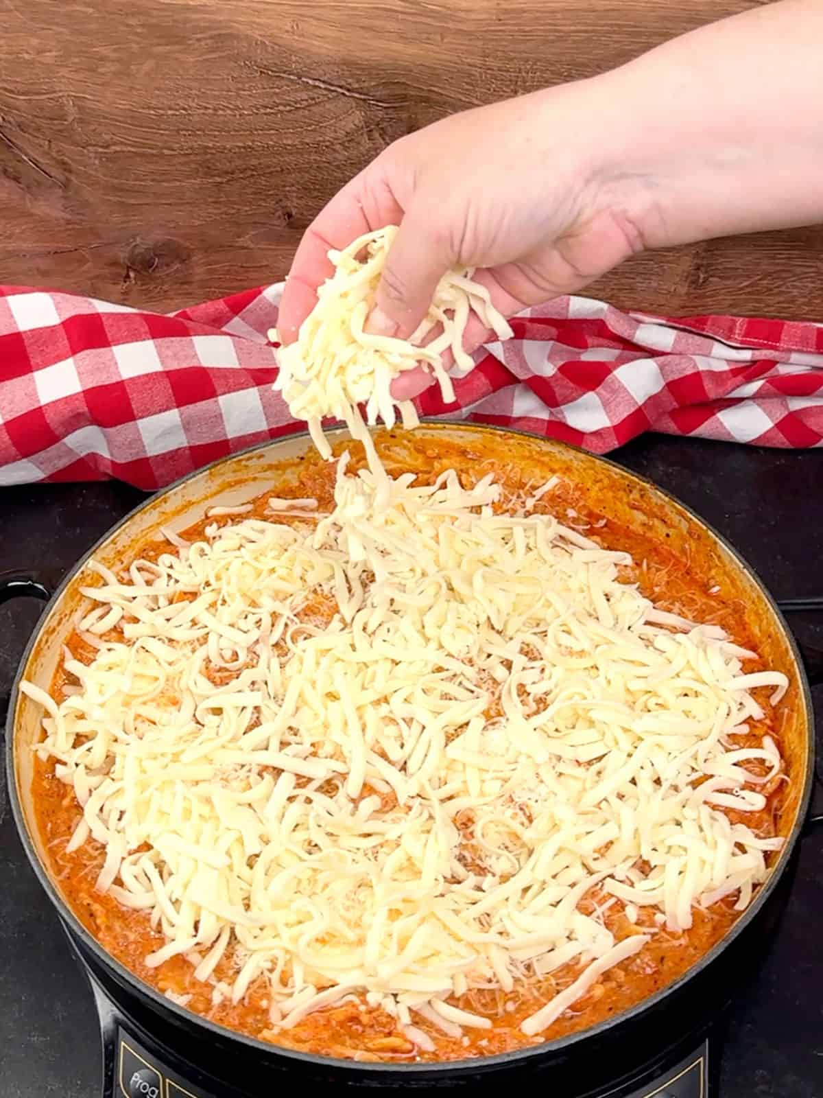 sprinkling mozzarella on top