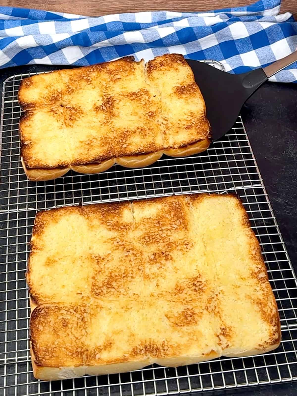 transferring toasted rolls to wire cooling rack
