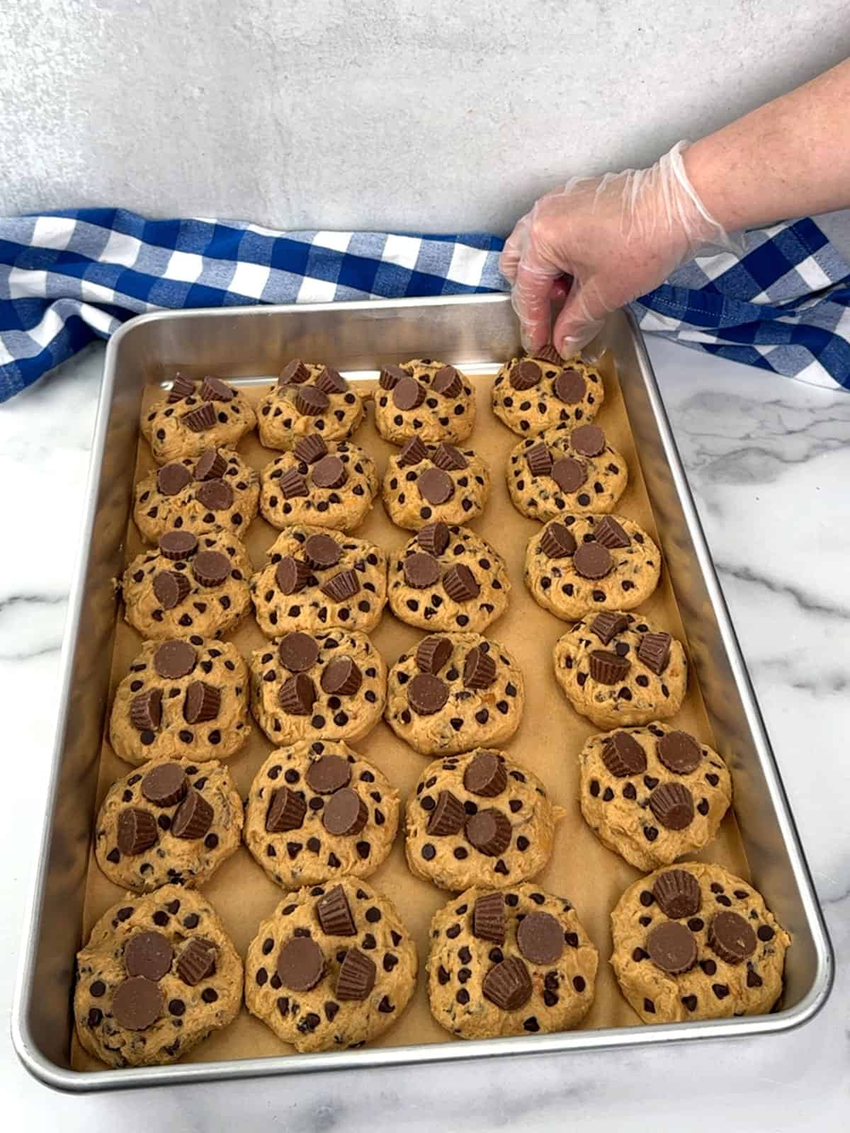 placing extra chocolate chips and Reese's into dough before refrigerating