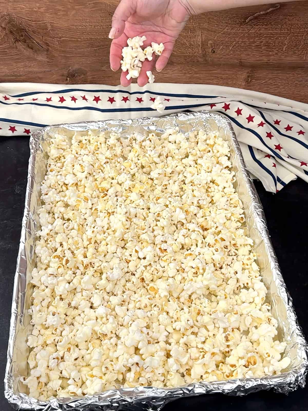 adding skinny pop to prepared pan.