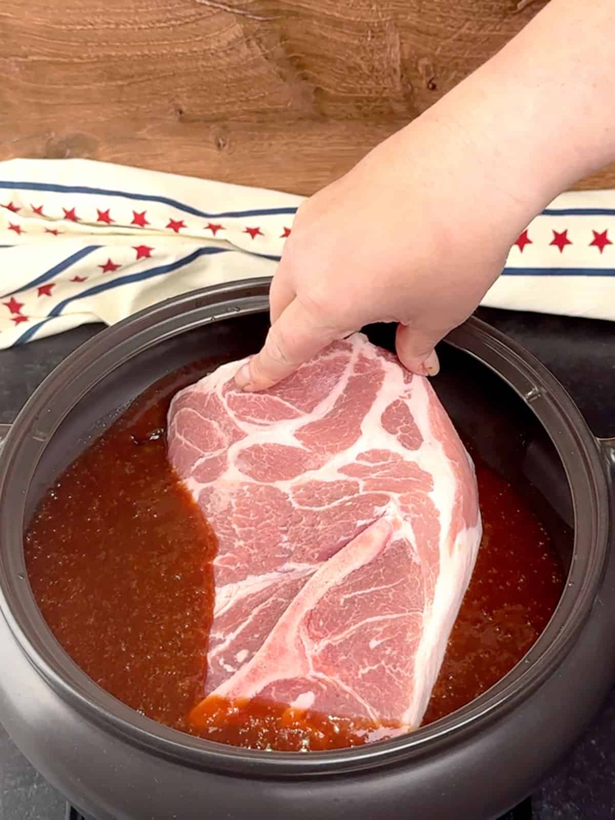 adding pork to slow cooker