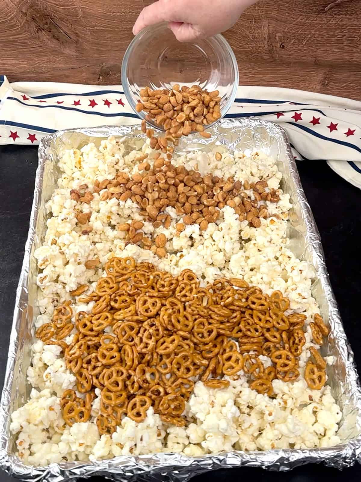 adding pretzels and peanuts