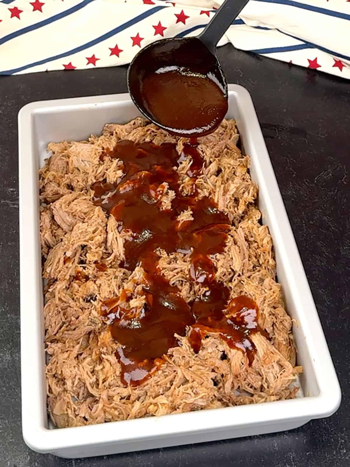 ladling reduced sauce over pork
