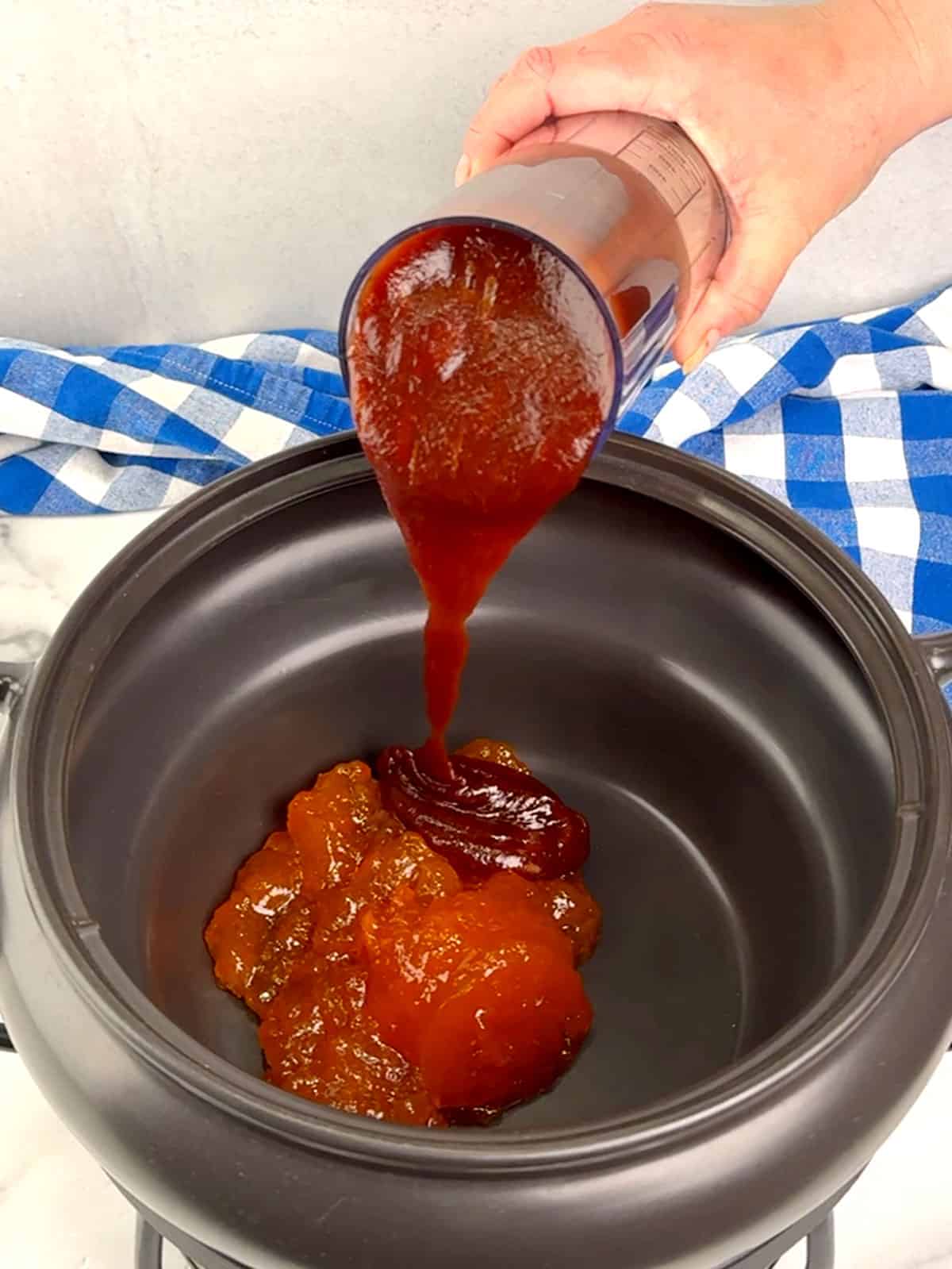 pouring sauces into crockpot