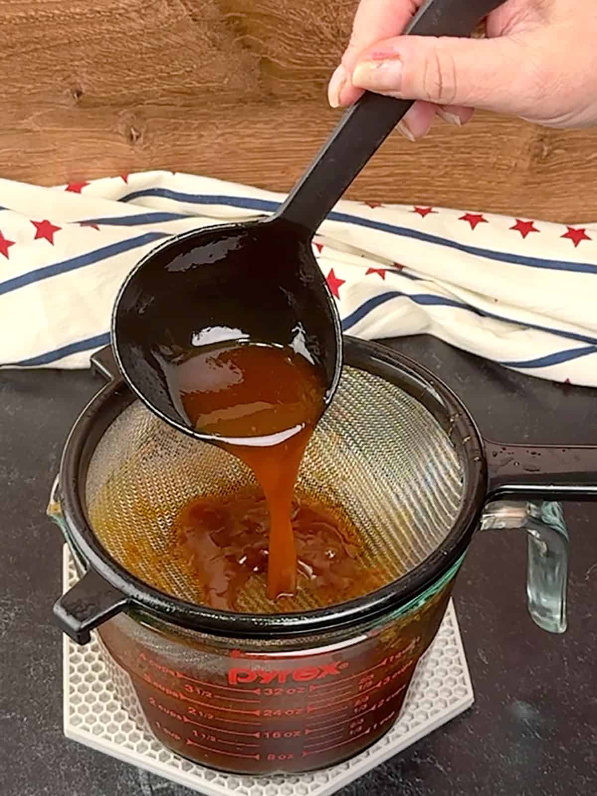 straining liquid from slow cooker