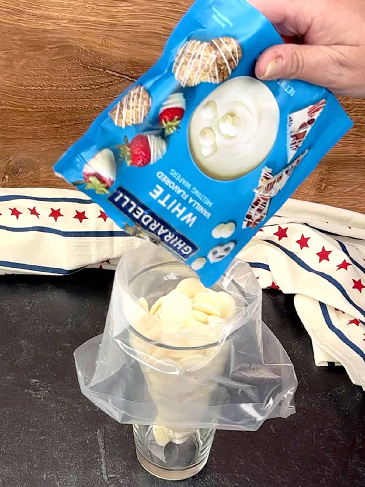 adding white chocolate melting wafers to piping bag