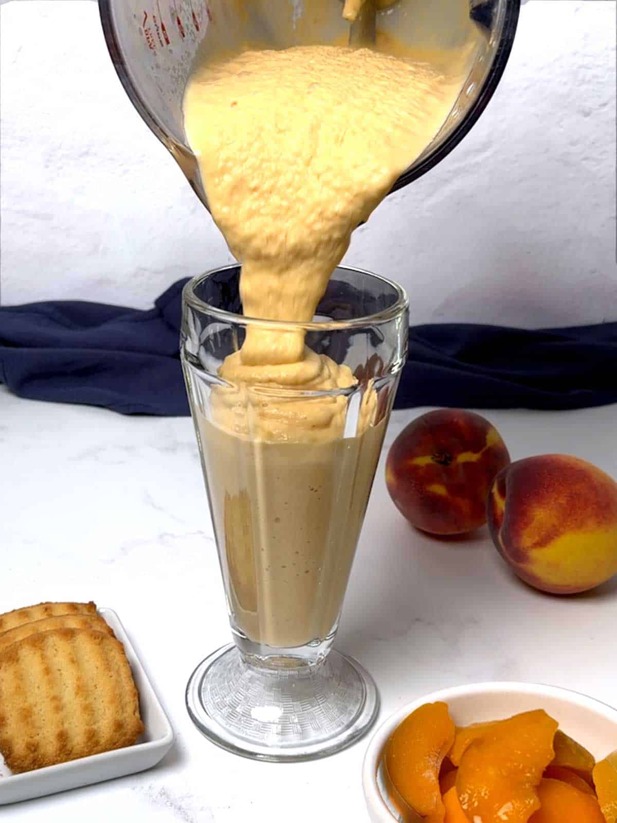 Pouring the smoothie into a glass.