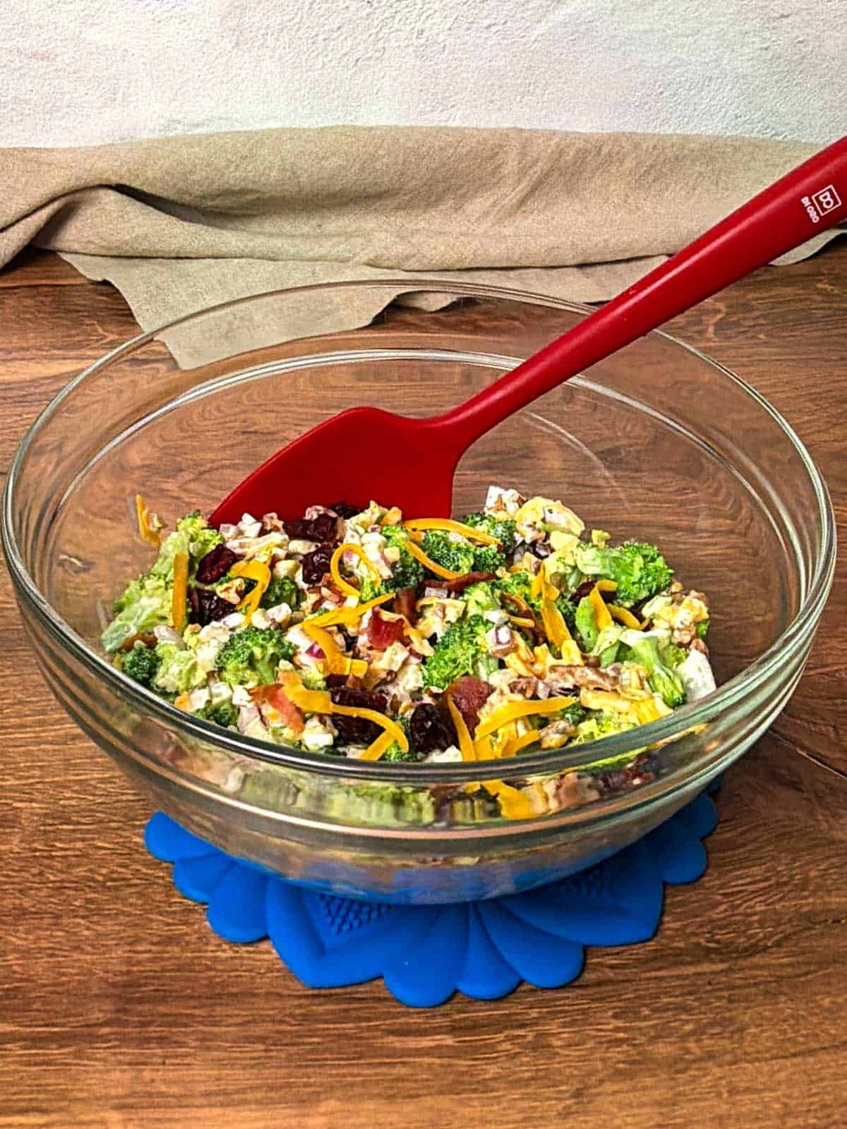 Broccoli Salad with red silicone spoon.